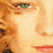 Pixelated close-up of a human eye and partial face with warm orange-yellow tones, likely from an animated film or character reference image.