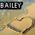 A four- of pixelated images with 'BAILEY' text overlays, each showing distinct visual content including a heart-shaped sand drawing, a colorful abstract swirl, and a blurred figure with a microphone