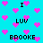 Pixelated cyan background with scattered pink hearts and repeated text phrases in black block letters.