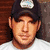 A pixelated image of a person wearing a dark cap and white shirt, with a child in blue shirt below, next to text reading "I Love Country Music" in bold black and white lettering.