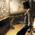 Pixelated static image of a person in motion with warm lighting and blurred background elements.