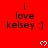 Red background with repeated black text "i love kelsey :)" and white pixel hearts arranged in a pattern