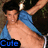 Pixelated image of a shirtless person with dark hair wearing a blue sleeveless top, holding a white object above their head against a dark background.