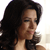 A static pixelated image of a person with long dark hair, light skin, and closed eyes, shown in profile against a bright background.