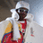 Pixelated image of a person in traditional attire with white headwrap and red-yellow garment, next to bright pink background with text "Soulja Girl <33".