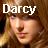 Pixelated image of a person with light brown hair and fair skin, overlaid with white text reading 'Darcy' in blocky font.