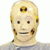 Pixelated static image of a humanoid figure with light skin tone, dark eyes, and a neutral expression wearing a gray top.