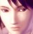 Pixelated close-up of a person's face with dark hair, light skin tones, and visible eyes and nose against a gradient background.