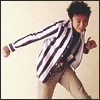 A person in a black-and-white striped jacket and beige pants appears in multiple poses with motion blur effects, some frames include inset close-up portraits.