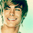 Pixelated portrait of a smiling person with green hair on left, blue background with pink text on right.