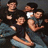 Group of people in casual clothing with text overlay asking 'Ever feel like an outsider?' on black background.