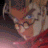Pixelated anime-style character with closed eyes and red clothing, displayed in a with text below