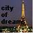 Pixelated image showing 'city of dreams' text over a nighttime cityscape with a tall illuminated tower and dark green foreground.