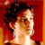 Pixelated profile view of a person with dark curly hair against a red and orange gradient background.