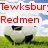 A soccer ball on grass with a blue sky background, overlaid with red text reading "Tewksburdbusting our butts Redmen so we can kick yours".