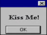 Static AIM buddy icon showing a dialog box with 'Kiss Me!' text and an OK button on a gray background.