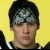 Yellow background with purple text and a pixelated image of a person wearing a black-and-white patterned headband.