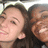 Two people in close proximity, one with dark hair and light skin, the other partially visible with brown tones.