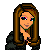 Pixelated character with long brown hair, green necklace, dark jacket over white shirt, and multicolored eyes.