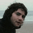 A pixelated image shows a person with dark hair against a light background, paired with blue text reading 'Is there Anybody that will listen To My story ... Across The Universe' on a solid blue field.