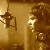 Pixelated golden-brown contact sheet showing two side-by-side frames of a cartoon character with curly hair and a striped dress, likely from an animated icon sequence.