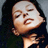 Static 256x256 pixel image of a person's face with closed eyes and slightly open mouth, dark hair against light background, visible facial features including nose, lips, and cheekbones.