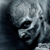 Pixelated grayscale image of a stylized human skull with visible eye sockets and nasal cavity, rendered in low-resolution 256x256 pixels on dark background.