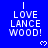 Blue background with white pixelated text reading "I LOVE LANCE WOOD!" and small heart symbols in a