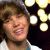 Four- of a person with brown hair in various poses and outfits against different backgrounds, including blurred lights and solid colors