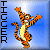 Pixelated cartoon tiger character with orange and black stripes, yellow belly, white mouth area, and blue background featuring vertical text "TIGER" on the left side.