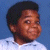 A pixelated image of a person with short dark hair wearing a white shirt against a blue background, next to green text reading 'Original Icons .com' on a dark green backdrop.