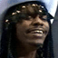 Pixelated close-up of a person with long dark hair and visible facial features including eyes, nose, mouth, and teeth.