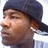 A person wearing a dark cap and earbuds appears in four showing slight head movement