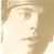 Pixelated close-up of a person's face with light skin tone, visible eye, nose, and mouth, set against a neutral beige background.