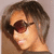 A person with short brown hair and dark sunglasses appears in four showing slight head position changes against a light background