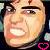 Pixelated close-up of a person's face with wide eyes, furrowed brows, and an open mouth showing teeth against dark background.
