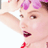 Static 48x48 pixel icon showing a close-up of a person with pink hair accessories, red lips, and raised arm against white background.