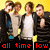 Four young men stand in a against a yellow background, wearing black jackets and white shirts, with red text below reading 'all time low' in pixelated font