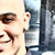 Pixelated close-up of a person's face with visible eye, nose, and mouth features against a blurred background.