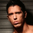 A four- with a shirtless man in the top-left, red text on black background in top-right, and black text on red background in bottom-left
