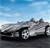 Pixelated image of a silver convertible car on a road under a blue sky with light clouds.