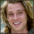 nine shows a person with long light brown hair smiling, with text elements appearing in the bottom-right