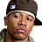 A pixelated image of a person wearing a brown cap with a white stripe and camouflage clothing, with green text overlay reading "STOMP THE YARD".