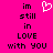 A static pixel art image with a bright pink background displays the phrase "im still in LOVE with you" in black text and a white heart symbol above the word "still."