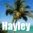Pixelated image of a person in mid-air with arms outstretched against a blue sky and green foliage background, overlaid with large white text reading "Hayley".