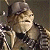 Pixelated image of a person with light brown hair wearing a dark jacket and black shirt, holding a sword-like object against a dark background.