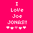 Pixelated text on bright pink background reads "I Love Joe JONAS!!" with five heart symbols below, two white, one pink, two white.