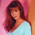 A pixelated image of a woman with long brown hair wearing a light blue top against a pink background, next to green text reading 'Original Icons .com' on dark green.