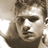 Pixelated grayscale portrait of a person with short hair, visible facial features including eyes and mouth, and partial shoulder/neck area in a static single-frame icon.