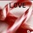 Red satin fabric with text overlays showing 'LOVE', 'CHRISTMAS', and '<3' in black font.